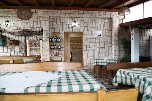 een restaurant met 2 tafels en een stenen muur bij Apartments with parking space Dol, Hvar - 24122 in Stari Grad