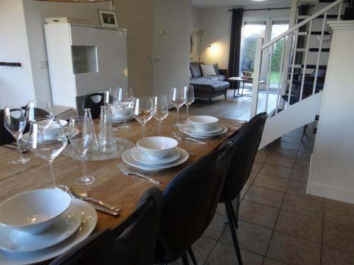 a dining room table with wine glasses on it at Vakantievilla Noordzee in Kamperland