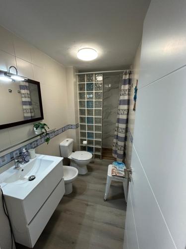 a bathroom with a white sink and a toilet at Casa Maja in Costa de Antigua