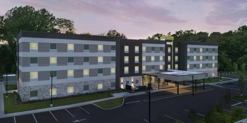 a rendering of a large building with a parking lot at Home2 Suites By Hilton Salisbury Fruitland in Fruitland