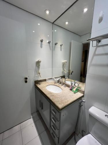 a bathroom with a sink and a mirror at Hotel Sena Madureira Ibirapuera Com Garagem 1210 in Sao Paulo