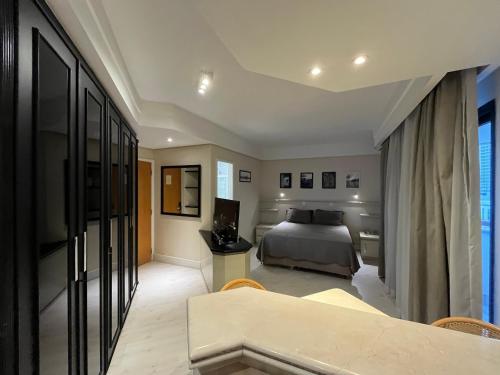 a bedroom with a bed and a table and chairs at Hotel Sena Madureira Ibirapuera Com Garagem 1210 in Sao Paulo