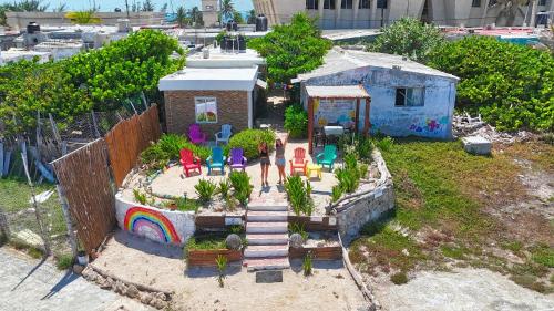 a toy house with a garden with chairs and a rainbow at "Casitas Arcoiris" Excelente ubicación - Petfriendly in Isla Mujeres