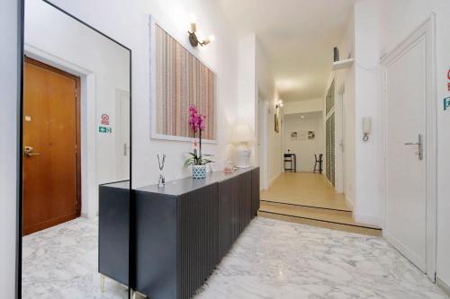 a hallway with a black dresser and a mirror at Foro Italico Guesthouse in Rome