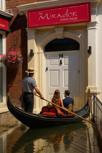 a group of people in a gondola going down a canal at Spend this night in Venice whilst visiting Swansea in Swansea