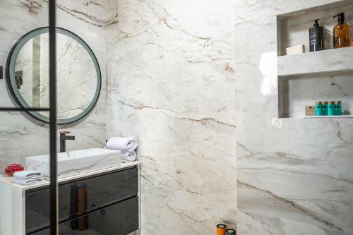 a bathroom with a sink and a mirror at Midnight Serenity in Čilipi