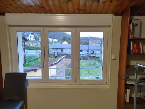 two windows in a room with a view at Gîte familial avec salle de jeux in Charency-Vezin