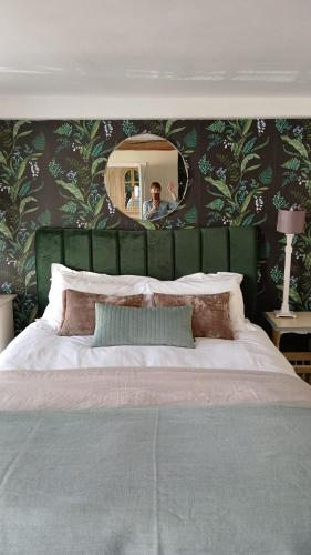 a man taking a picture of a bed in a bedroom at Earsham Street House in Bungay