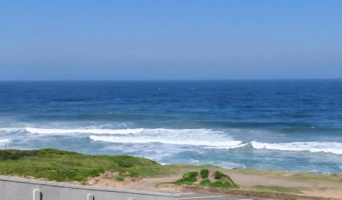 a view of the ocean from a highway at Modern Beachfront Escape in La Mercy in La Mercy