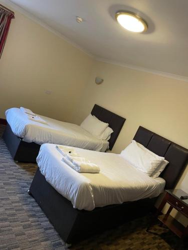 a hotel room with two beds in a room at Lochway Hotel in Dumbarton