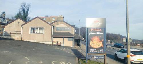 a pizzaburning sign on the side of a street at Lochway Hotel in Dumbarton
