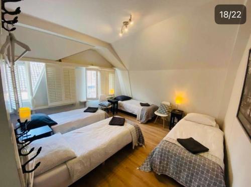 a bedroom with two beds and a living room at Lovely Apartment Wassenaar 6P in Wassenaar