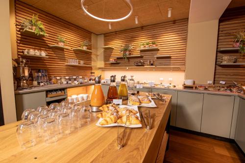 a long table with plates of food and wine glasses at Hotel Birkenhof in Hanau am Main