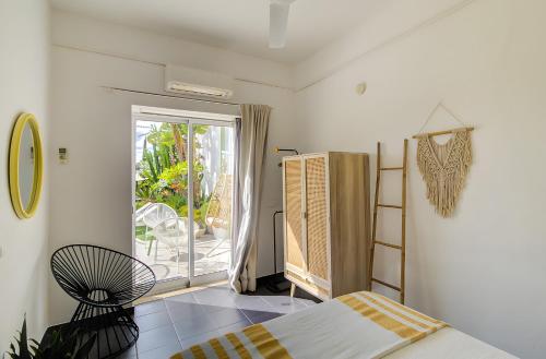 ein Schlafzimmer mit einem Bett und ein Fenster mit einer Terrasse in der Unterkunft Vila Rafa in Albufeira