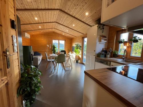 a kitchen and living room with a table and chairs at Ferienhaus In Atzenhain Mit Großer Terrasse in Mücke