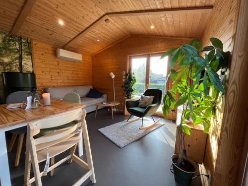 a living room with a couch and a table at Ferienhaus In Atzenhain Mit Großer Terrasse in Mücke
