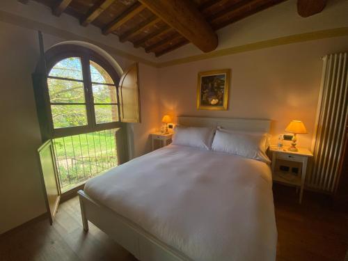 Ένα ή περισσότερα κρεβάτια σε δωμάτιο στο Borgo Sette Tigli