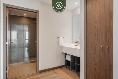 a bathroom with a sink and a shower at 1BR Condo in Polanco - Pool - Coworking - CityView in Mexico City