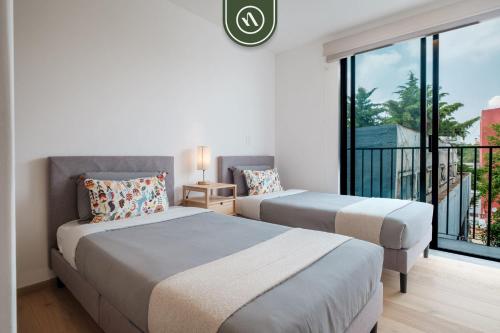 Ένα ή περισσότερα κρεβάτια σε δωμάτιο στο Luxury 2 BR Condo in Condesa