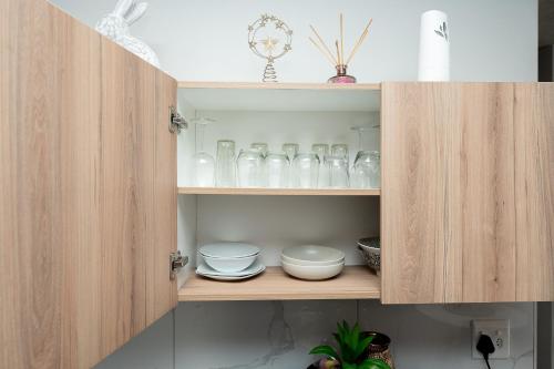 a cupboard with dishes and glass items in it at K47 propertyzz in Midrand
