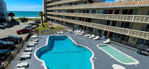an aerial view of a hotel with a swimming pool and the ocean at Viking Motel in Myrtle Beach
