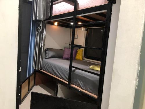a small room with a bunk bed in it at Den Nest Hostel KRABI in Ban Nong Chaeng