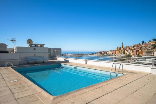 a swimming pool on the roof of a building at LE SUN - Central - Piscine - Wifi in Menton