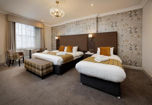 a hotel room with two beds and a table at New Town Hotel in Edinburgh