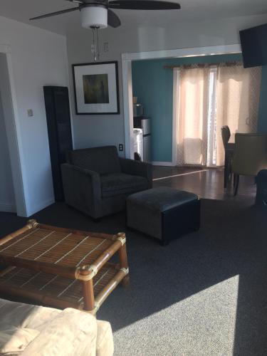 a living room with a couch and a chair at Dolphin Cove Motel in Pismo Beach