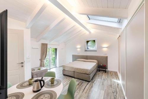 a bedroom with a bed and a table and chairs at Agave Apartment in Vico Equense