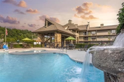 a pool at a resort with a waterfall at Best Western Plaza Inn in Pigeon Forge