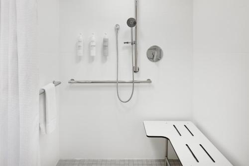a shower in a white bathroom with a sink at Home2 Suites By Hilton Cleveland, TN in Cleveland