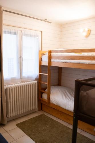 丰罗穆Altitude 1711 - Terrasse en hyper-centre的客房设有两张双层床和散热器。