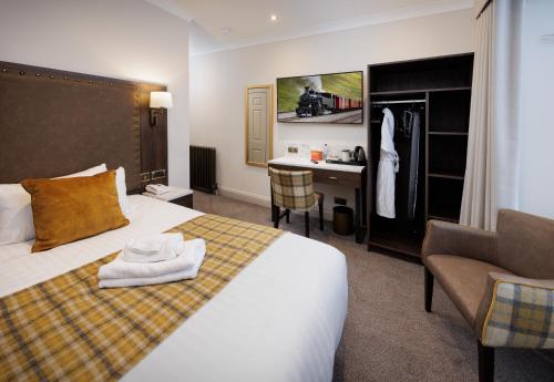 a bedroom with a bed and a desk and a chair at New Town Hotel in Edinburgh