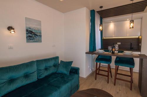 a living room with a couch and a table at Vila Vujic Tara in Kaludjerske Bare