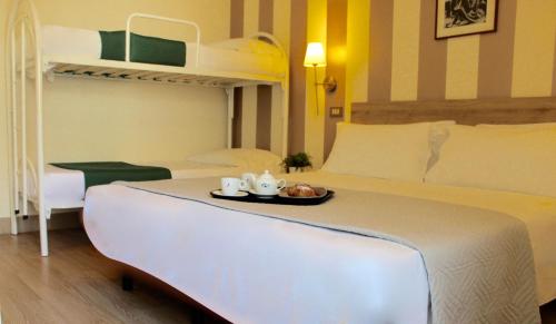 una camera da letto con un letto con un vassoio di cibo sopra di King Hotel a Cesenatico