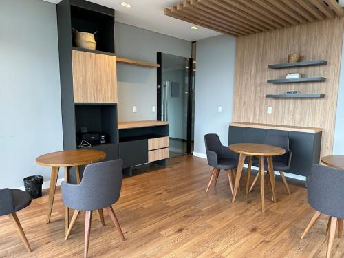 a dining room with two tables and chairs at More deluxe sol in Asuncion