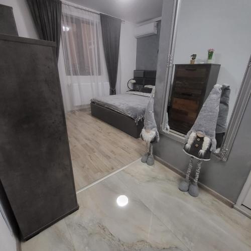 a bedroom with a bed and a large mirror at Pensiunea Balta Lazar in Alexandria