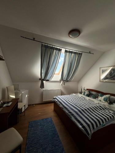 a bedroom with a large bed and a window at Penzión Korytnačka in Námestovo