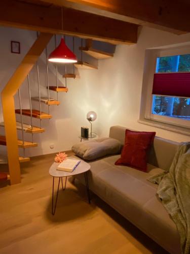 a living room with a couch and a staircase at "Nestl" in Bad Häring