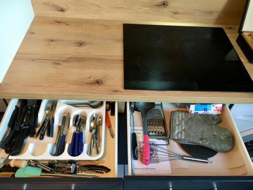 a wooden drawer filled with lots of different tools at T3 cozy Saint Genis Laval - balcony - quiet - HLS in Saint-Genis-Laval