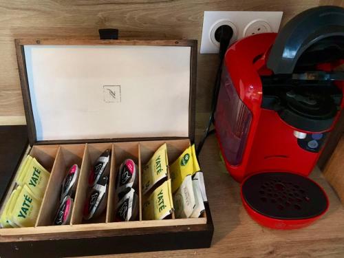 a box full of knives sitting next to a toaster at T3 cozy Saint Genis Laval - balcony - quiet - HLS in Saint-Genis-Laval