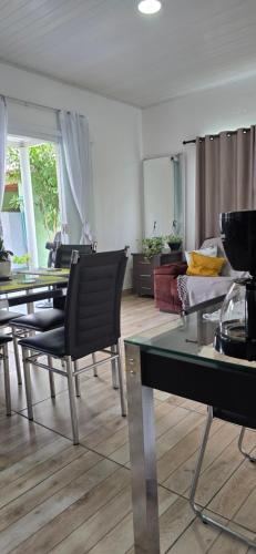 a living room with tables and chairs and a couch at Mecejana Home in Boa Vista
