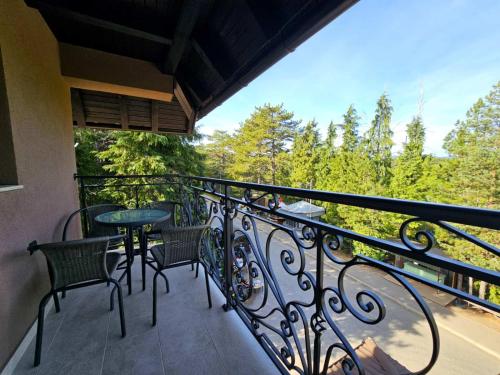 a balcony with chairs and a table with a view at Vila Vujic Tara in Kaludjerske Bare