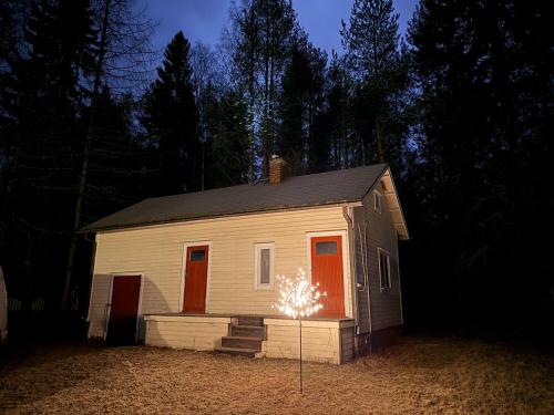 a small house with a sparkler in front of it at Holiday home on the edge of the woods in Kemijärvi