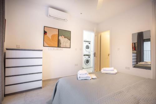 a white room with a bed and a washing machine at Two Bedroom House In Town Center by Sweet Keys in Limassol
