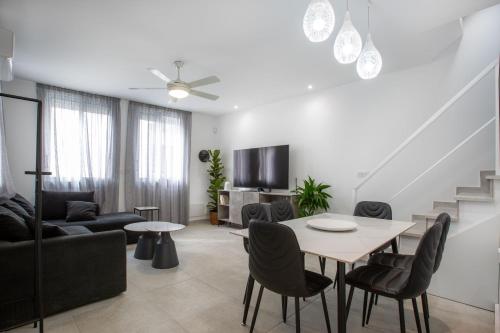 a white living room with a table and chairs at Two Bedroom House In Town Center by Sweet Keys in Limassol