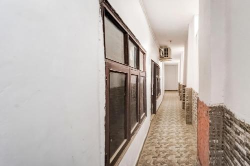 a corridor of a building with a door on the side at SPOT ON Gorav Smark in Malhour
