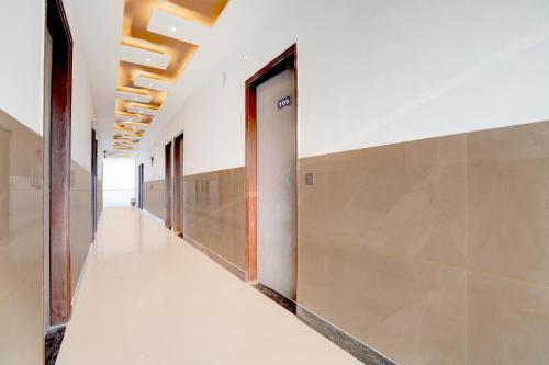 an empty hallway of an office building with a door at SPOT ON G Grand Hotel in Narela