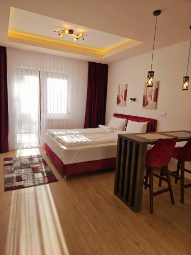 a bedroom with a bed and a table in it at Vila Vujic Tara in Kaludjerske Bare